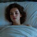 Relaxed person sleeping in a bed